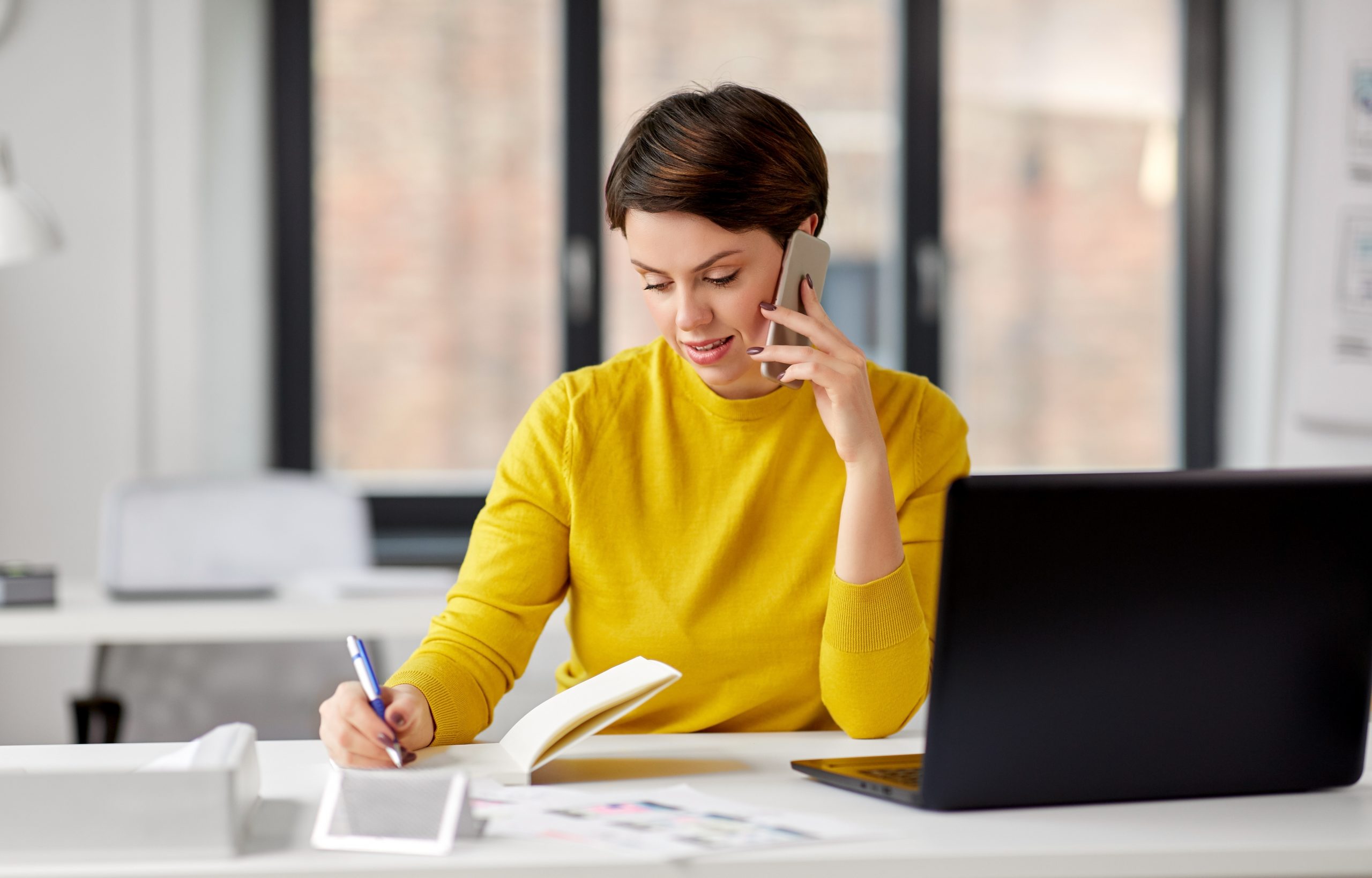 businesswoman calling on smartphone at office